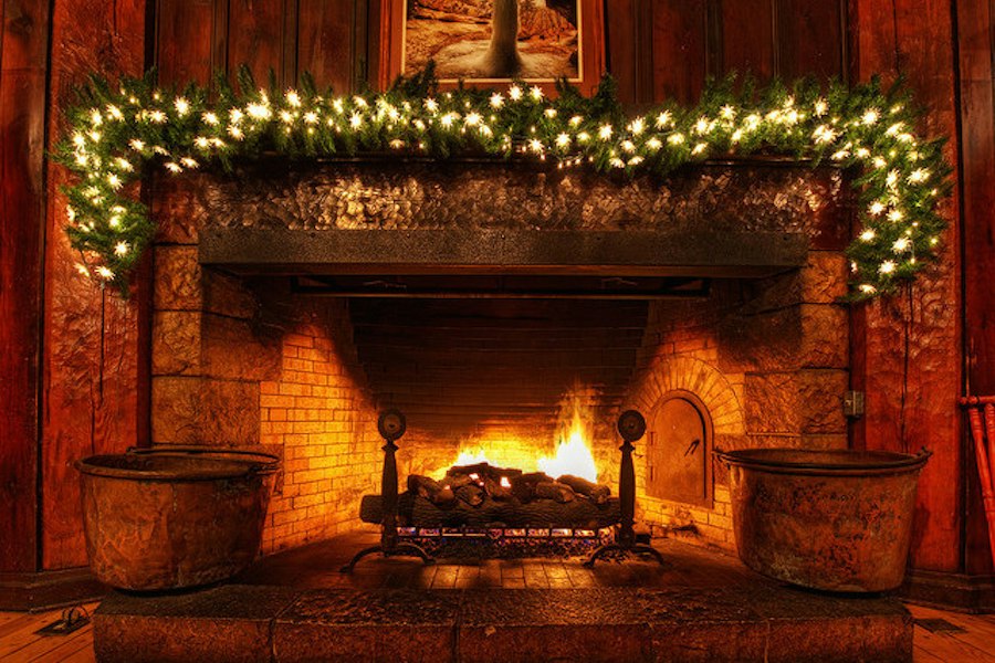 A fireplace dressed for the holidays